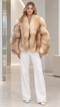 Front view of model wearing Natural Beige plush faux fur jacket with white wide-leg trousers
