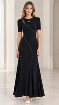 Front full-length view of woman wearing black beaded cutout mermaid maxi evening dress