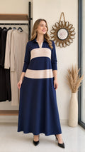 Front full-length view of woman wearing navy blue and beige colorblock polo maxi dress