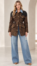 Full front view of model wearing brown leopard print utility jacket with denim collar and wide-leg jeans