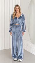 Front view of woman wearing dusty blue velour cropped hoodie and wide leg pants set