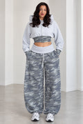 Front view of model wearing Heather Grey cropped zip hoodie and wide leg camo sweatpants set