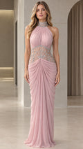 Front view of model wearing Blush Pink halter maxi evening gown with rhinestone waist