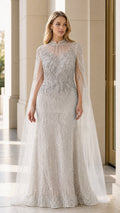 Front view of model wearing silver beaded evening gown with sheer cape overlay