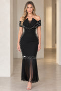 Front view of model wearing black off-the-shoulder pearl embellished maxi dress with fringe hem