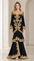Full-length front view of black evening gown with gold embroidery and tiered mermaid skirt