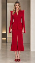 Front view of model wearing the sculpted red blazer and slit midi skirt set