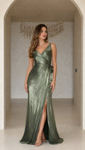 Full-length front view of model in olive green sleeveless metallic pleated evening gown with high leg slit