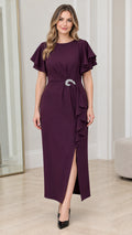 Front full view of woman wearing Plum flutter sleeve maxi dress with crystal brooch and side slit