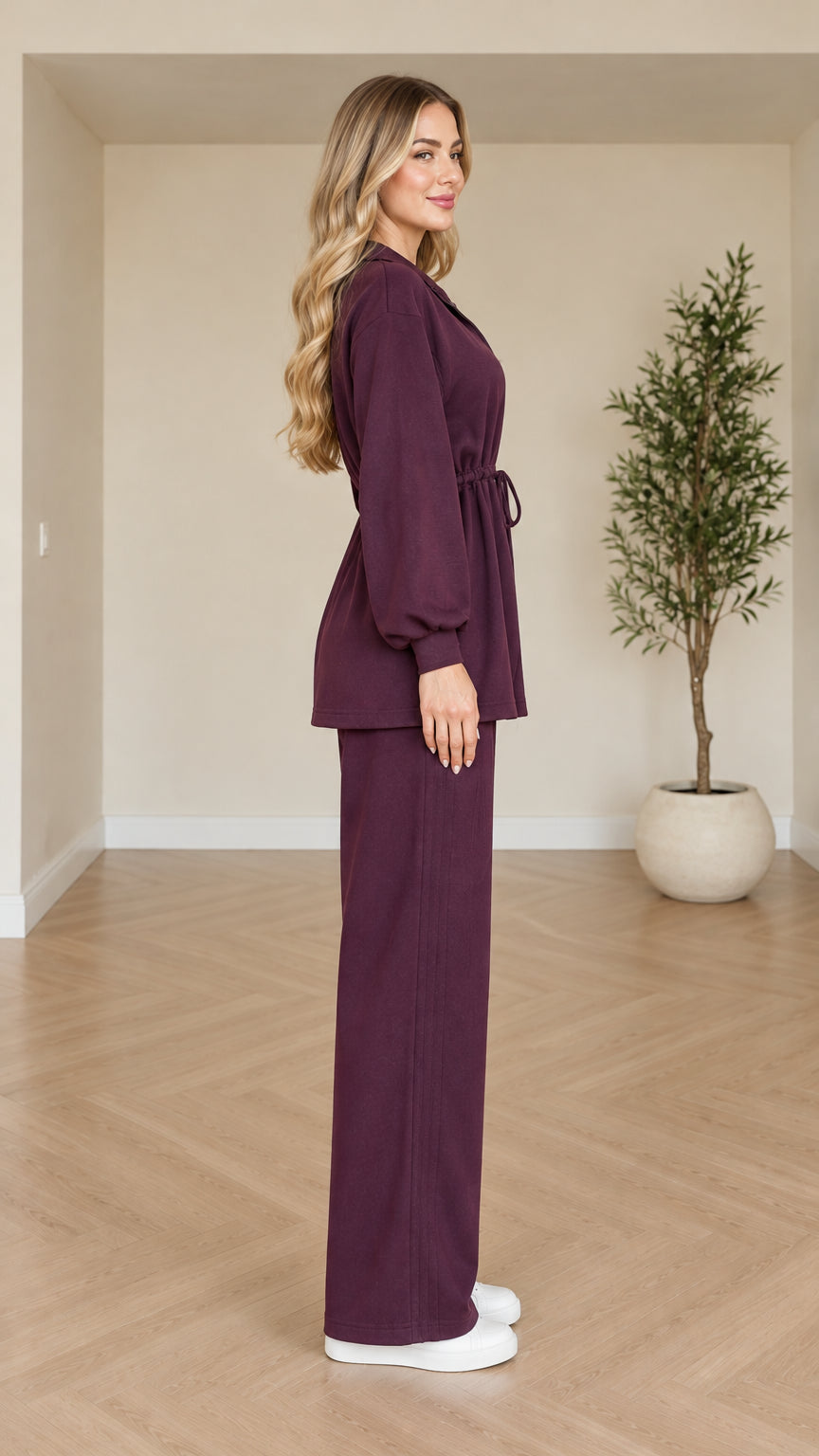 Side profile view of plum two-piece casual set featuring wide-leg trousers