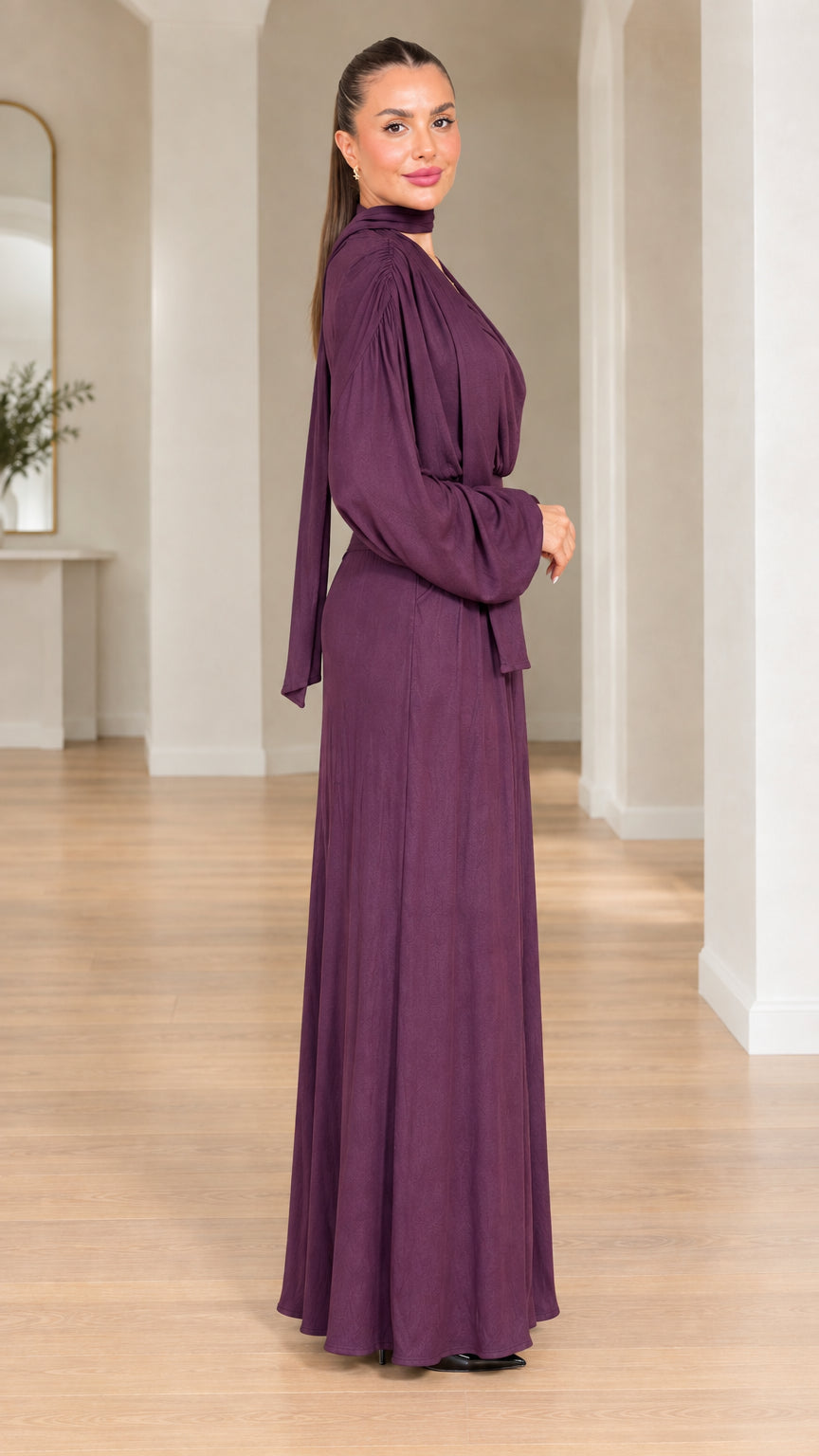 Side view of model in plum elegant wide-leg evening jumpsuit