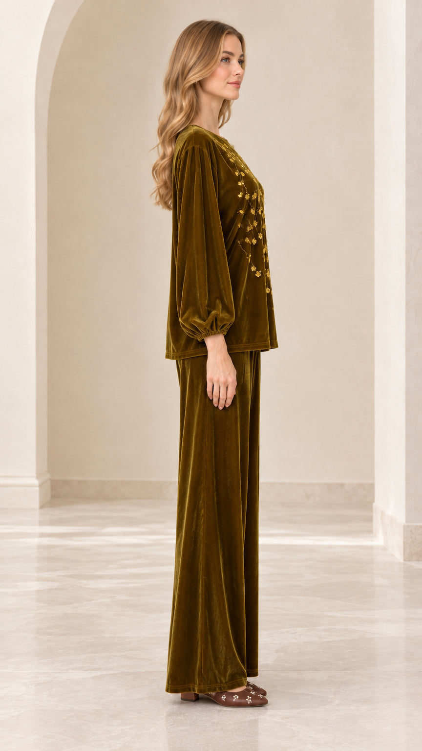 Side view of model wearing olive green velvet balloon sleeve top and wide leg pants