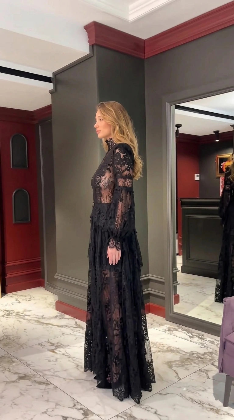 Side profile of woman in Black sheer lace floor-length evening gown