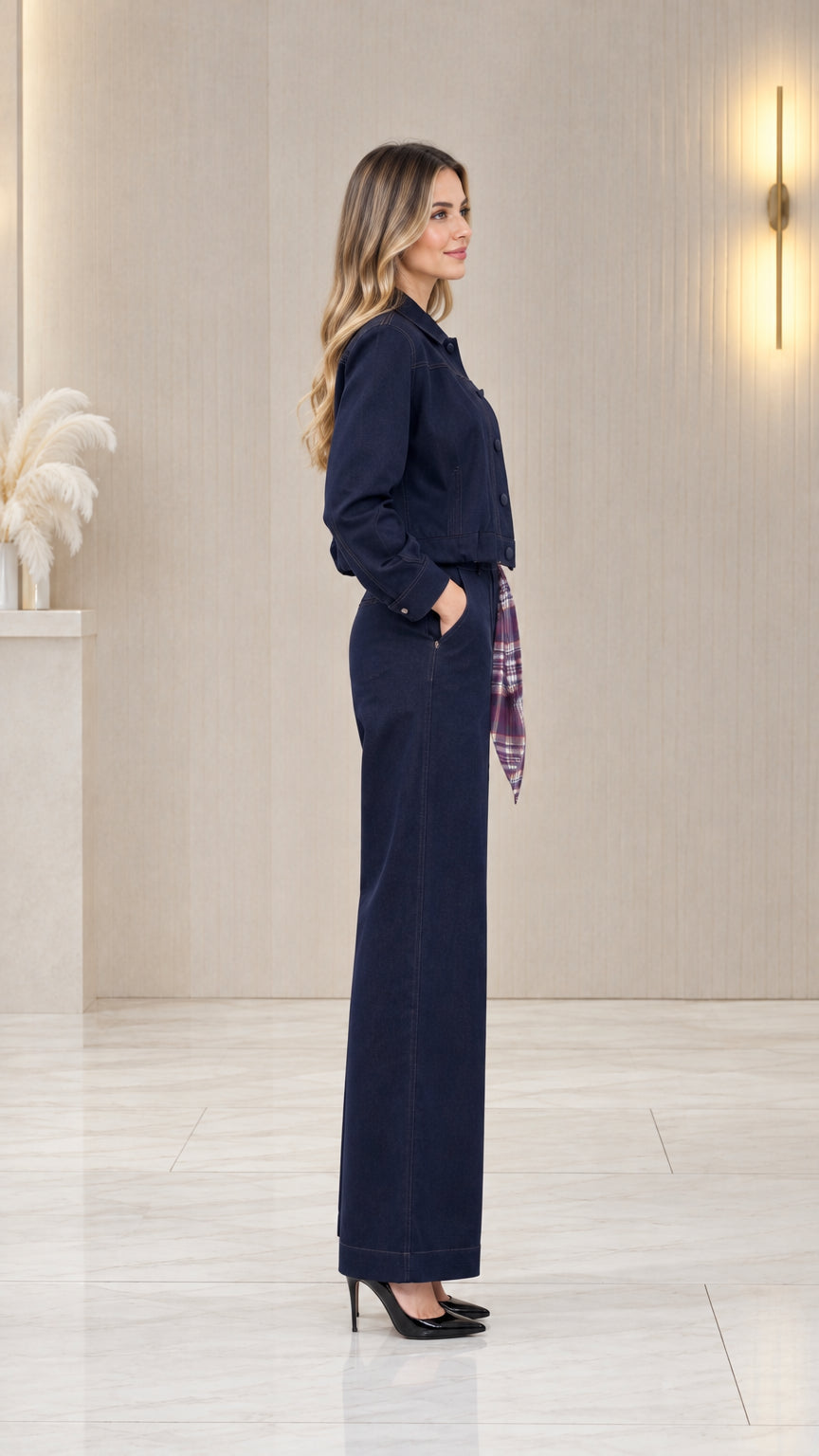 Side profile view of women's navy blue two-piece jacket and wide-leg pants set