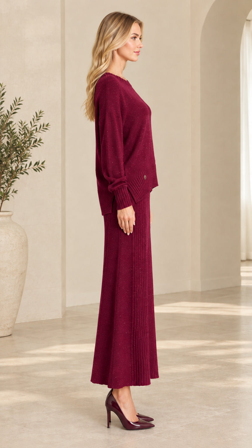 Side profile view of burgundy knit sweater and matching ribbed maxi skirt set