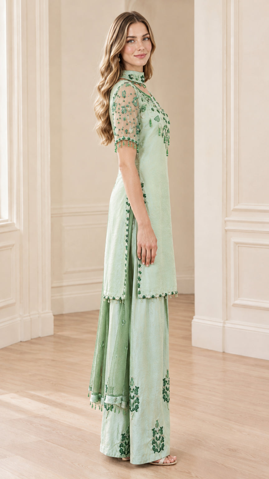 Side angle view of model wearing Sage Green embellished tunic set with sheer sleeves