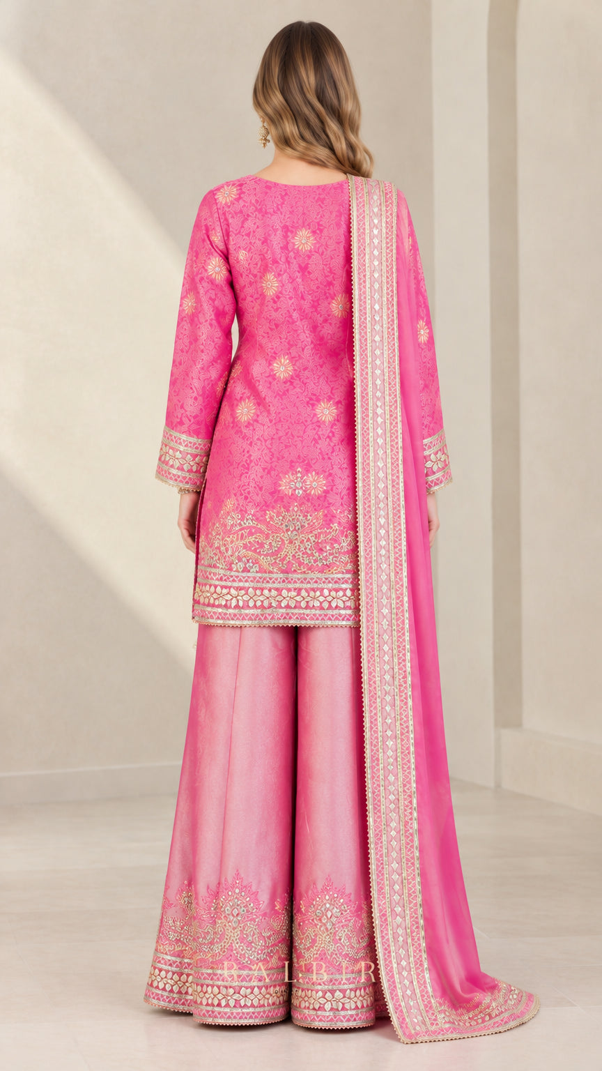 Back view of woman wearing Fuchsia Pink embroidered ethnic suit set with drape