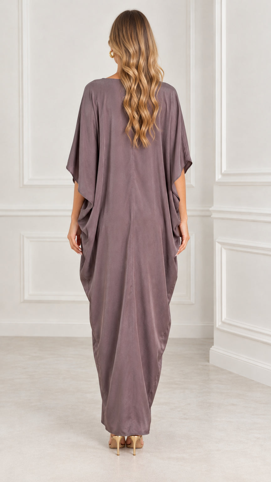 Back view of model wearing mauve flowing kaftan maxi dress