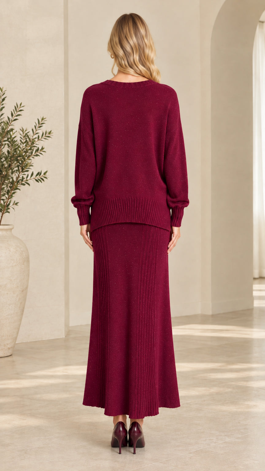 Back view of burgundy shimmer knit two-piece sweater and long skirt set