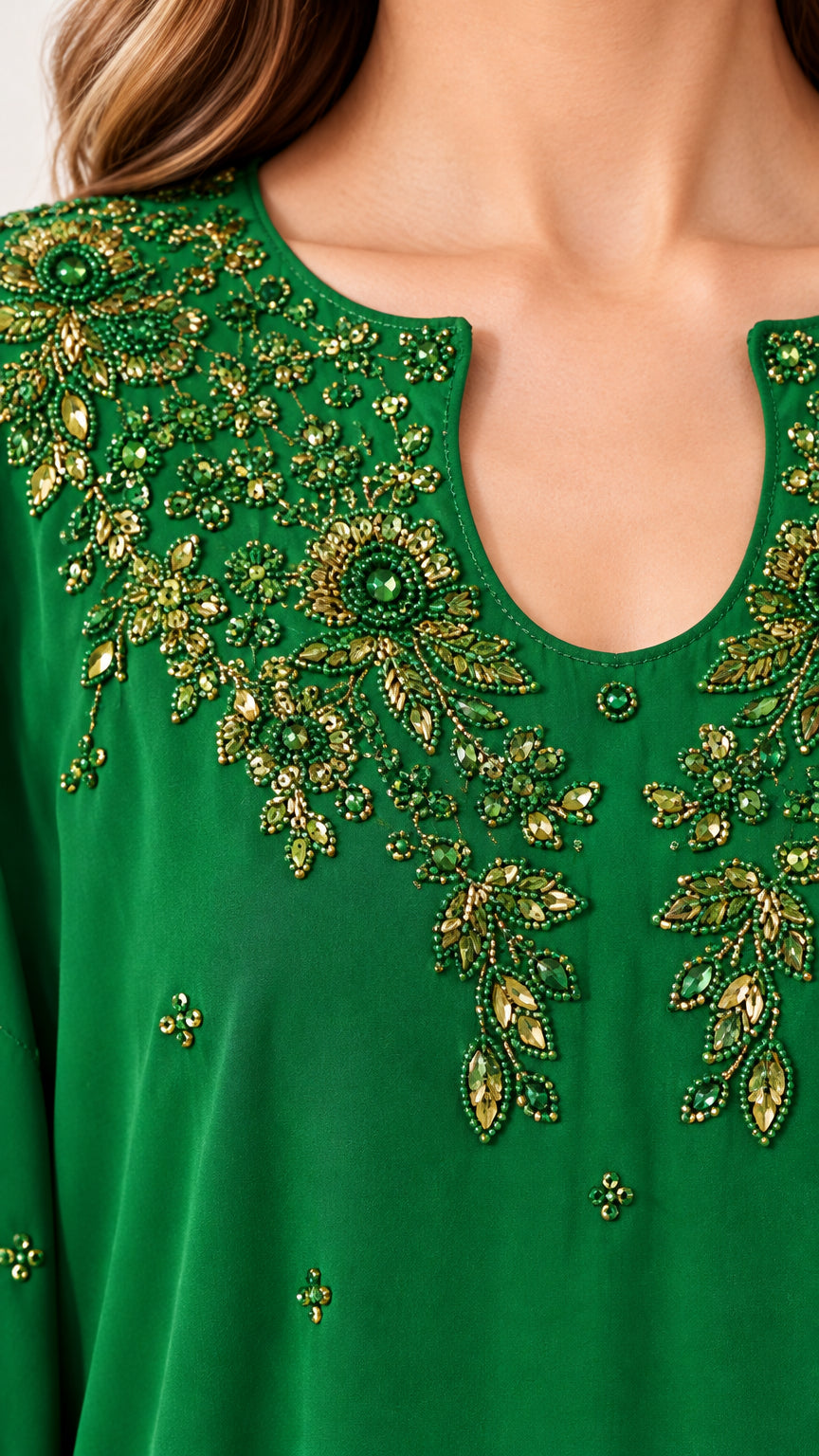 Close-up of intricate floral beading on neckline of emerald green kaftan