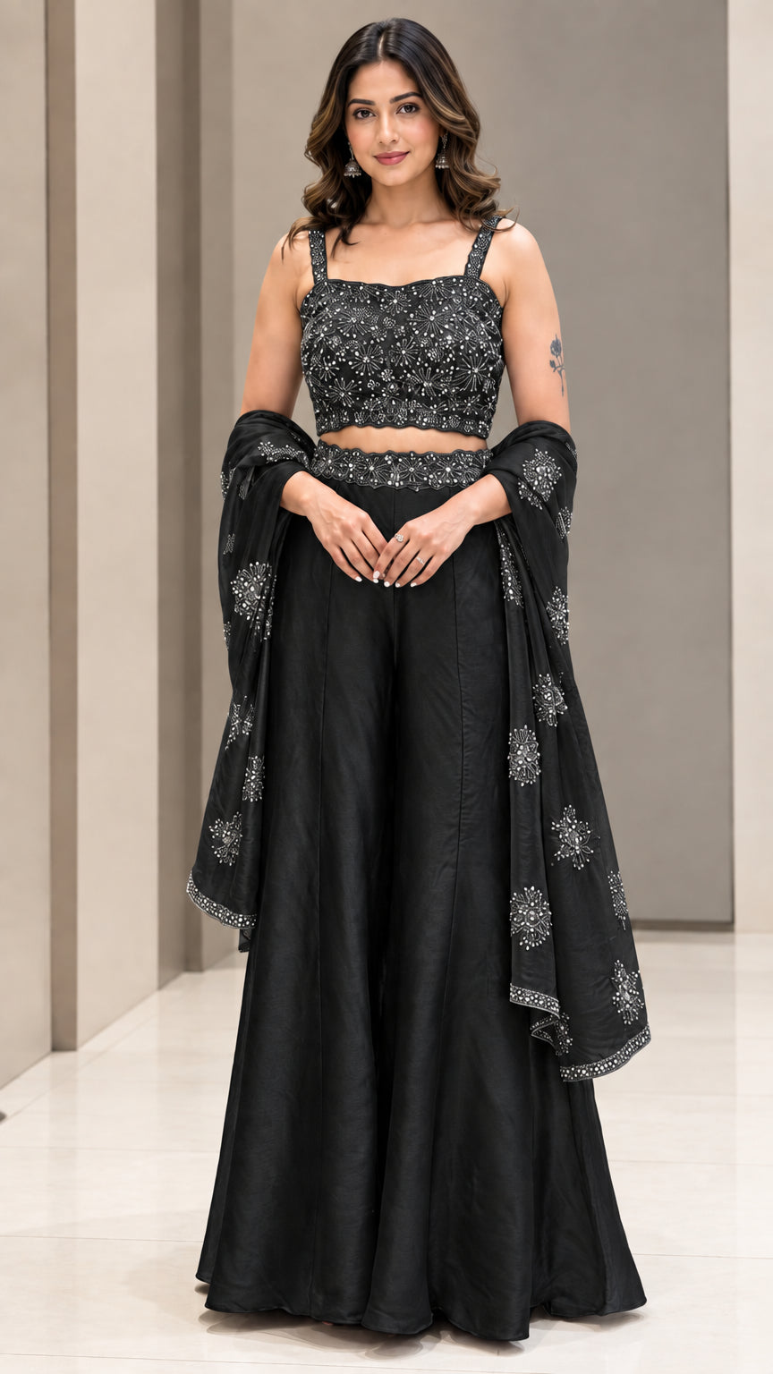 Full-length studio view of woman wearing Black embroidered crop top and wide-leg palazzo pant set