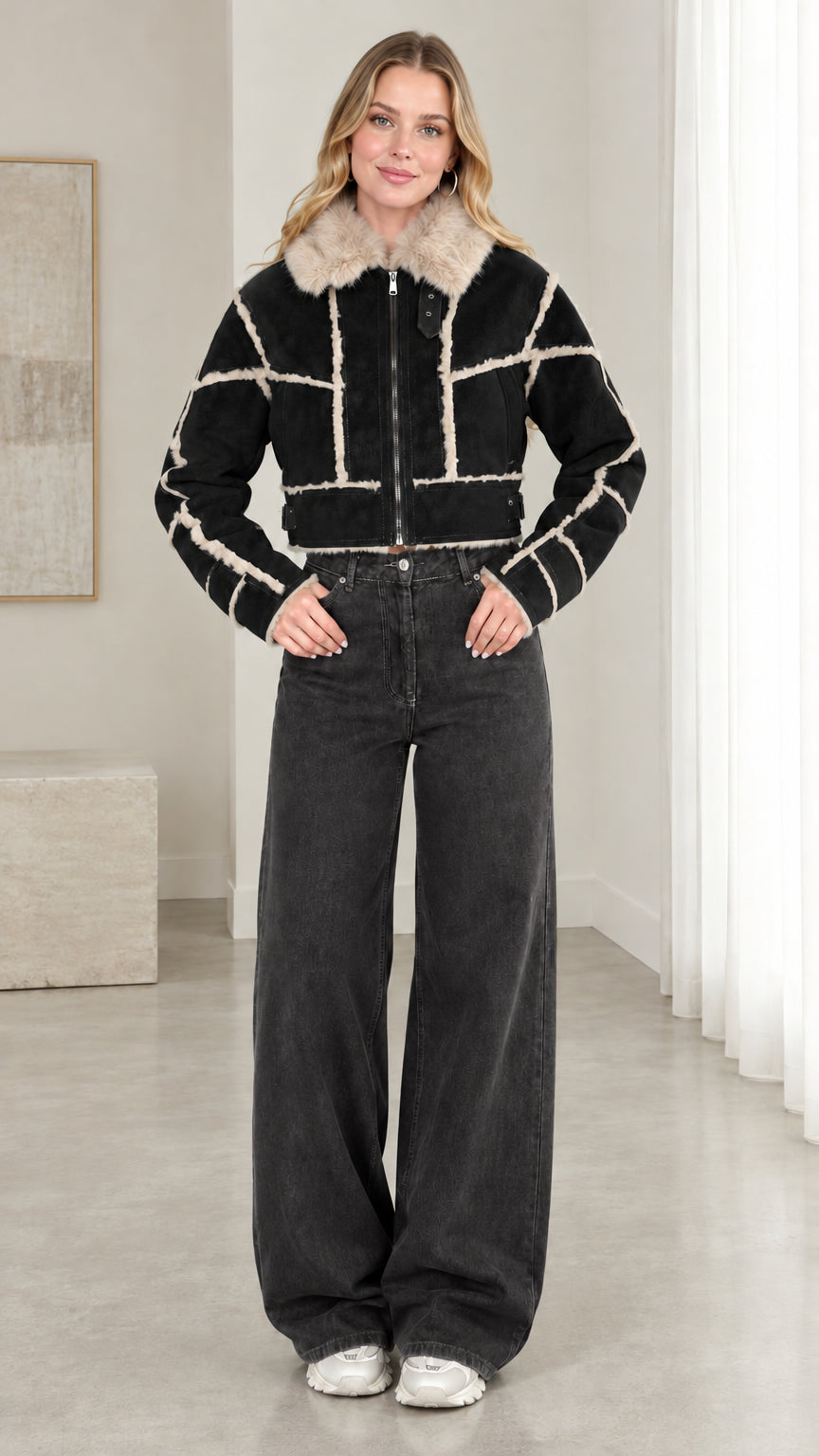 Model wearing black cropped faux suede shearling jacket with dark wash jeans