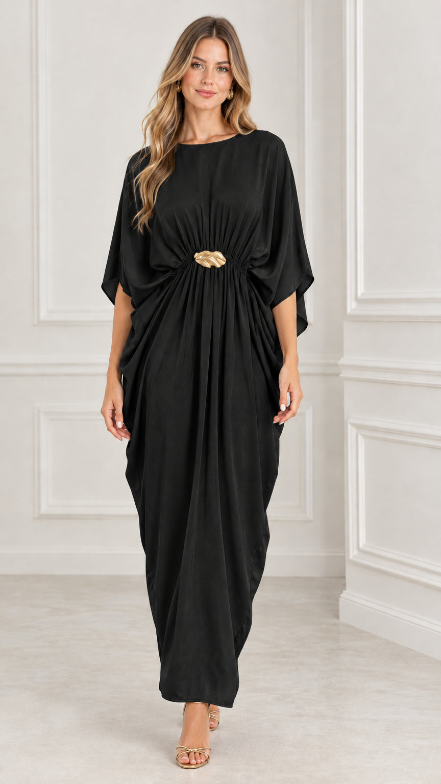 Front view of black draped batwing kaftan maxi dress with gold buckle