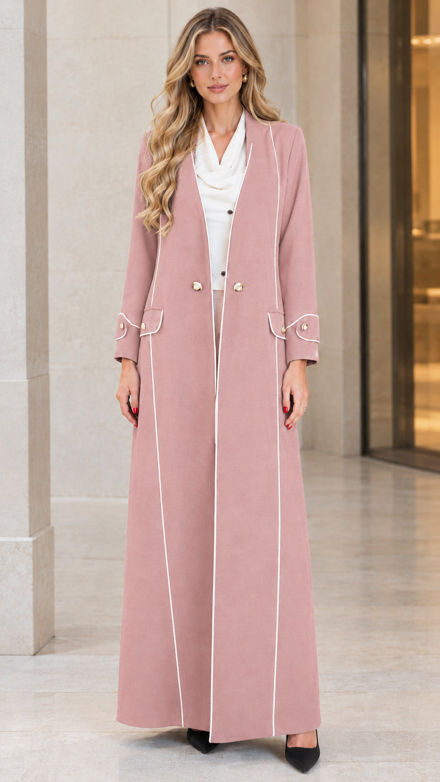 Front view of woman wearing dusty pink longline maxi coat with white piping