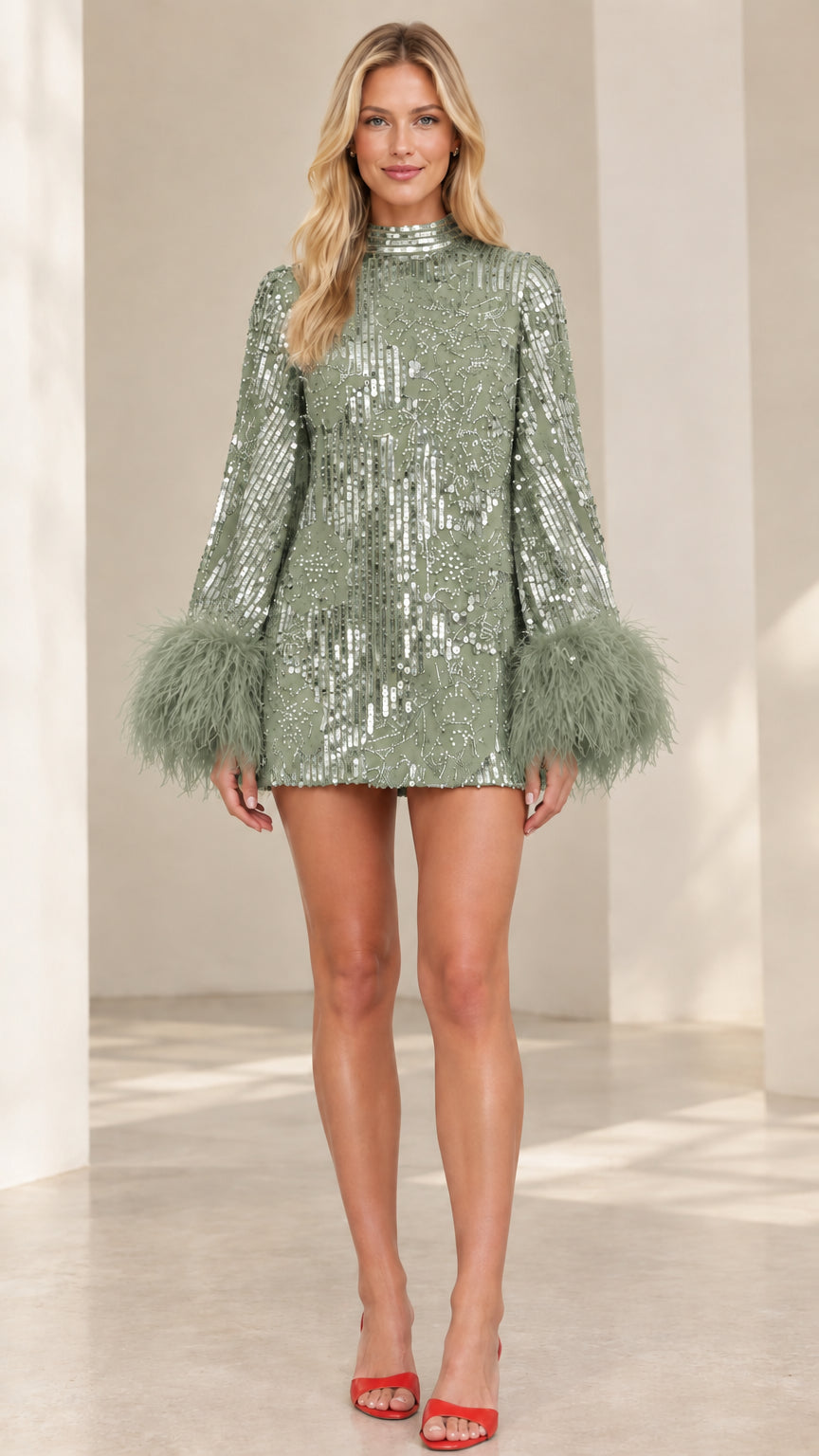 Model wearing sage green sequin mini dress with matching feather cuffs