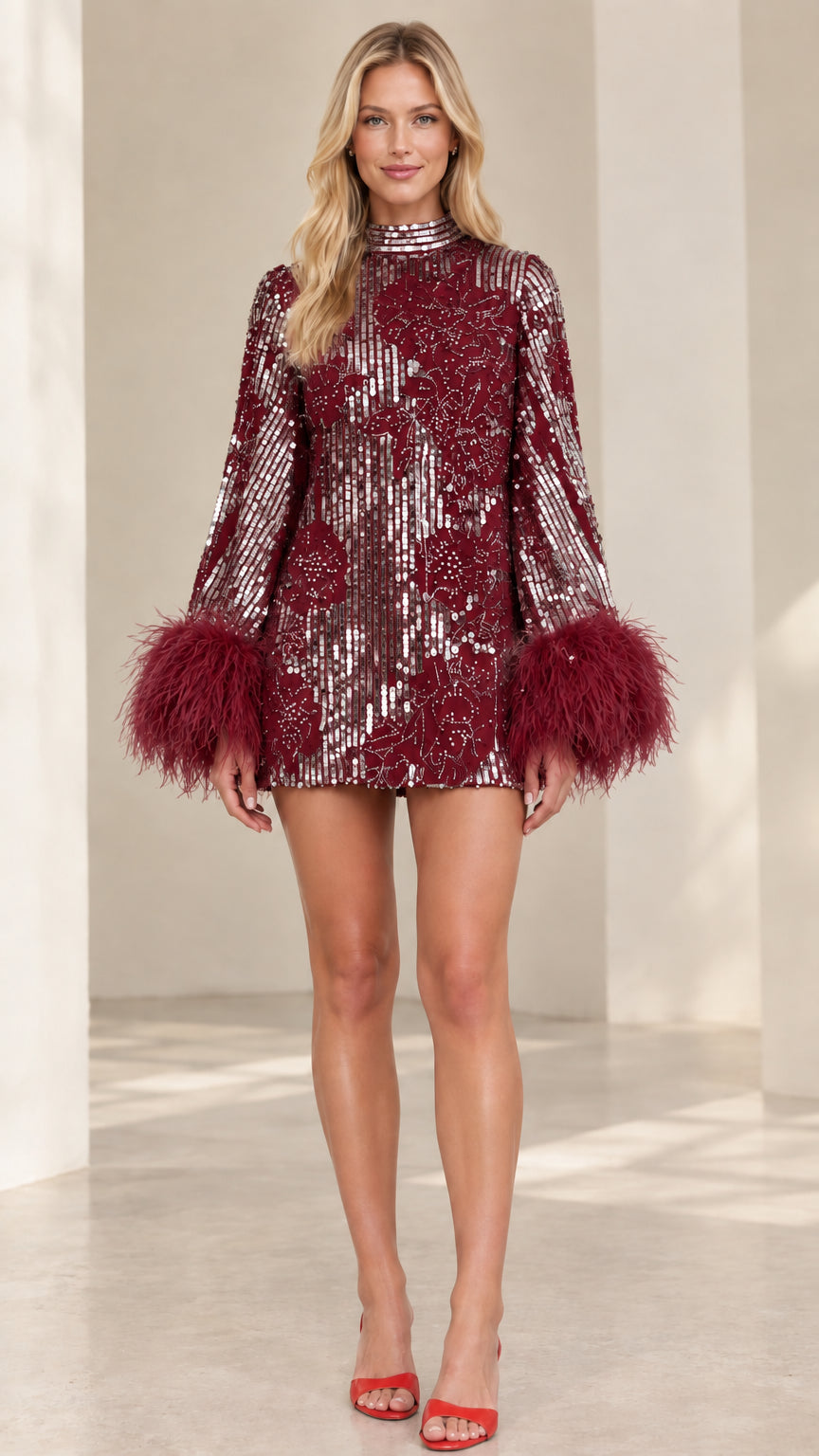 Model wearing burgundy wine sequin mini dress with matching feather cuffs