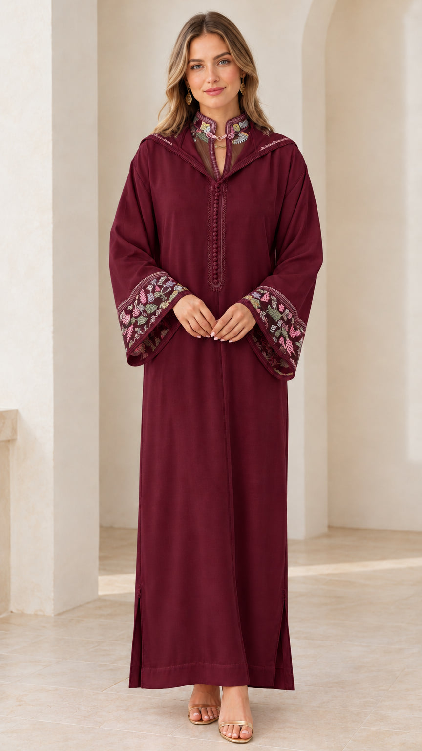 Model wearing burgundy embroidered hooded djellaba maxi dress