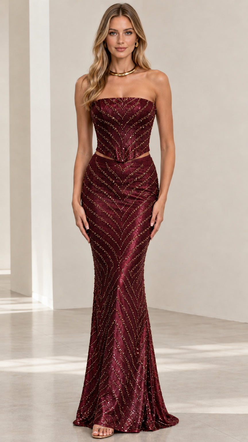 Front view of burgundy beaded strapless two-piece evening gown