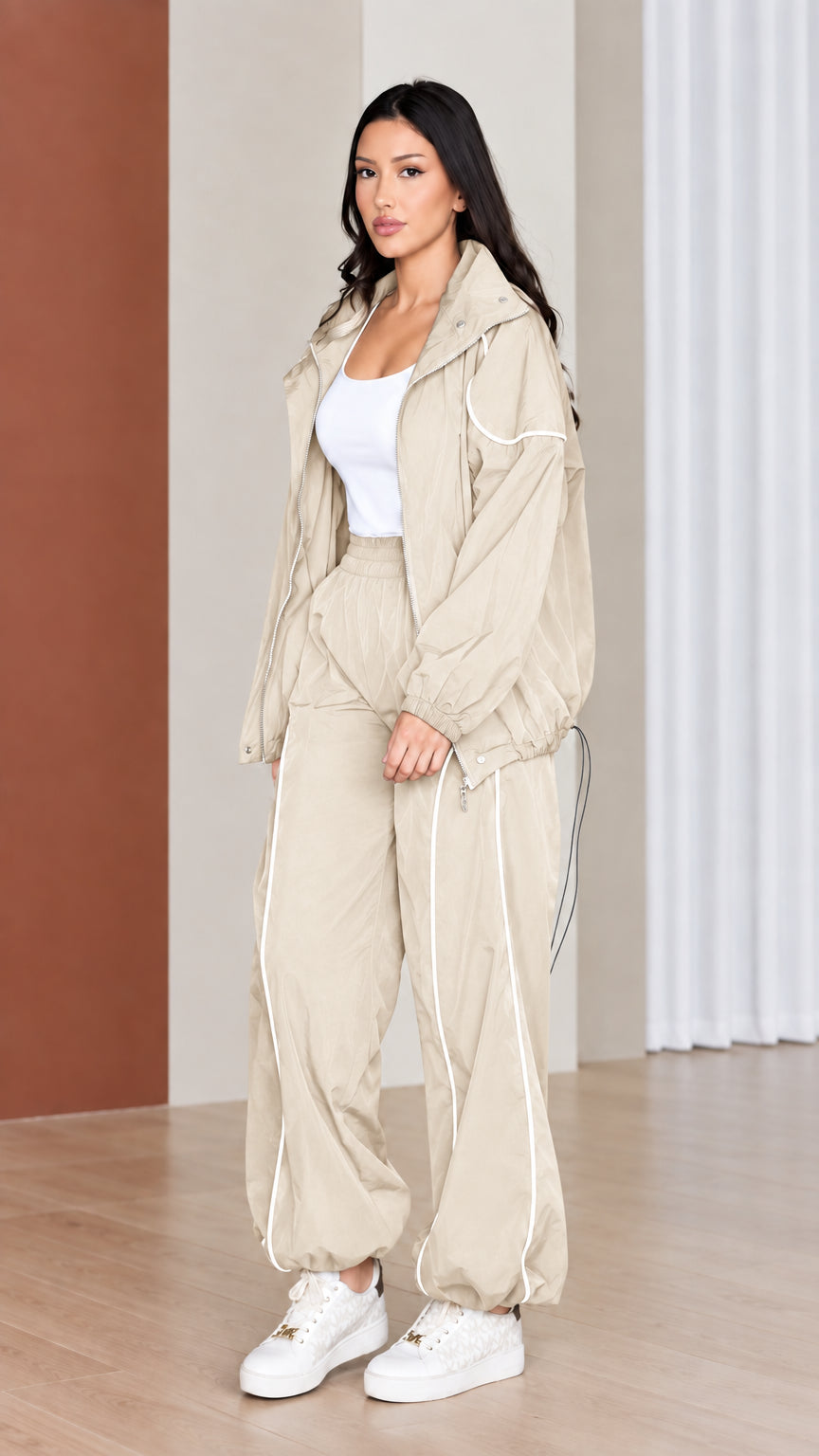 Full-length view of woman wearing neutral beige windbreaker tracksuit set